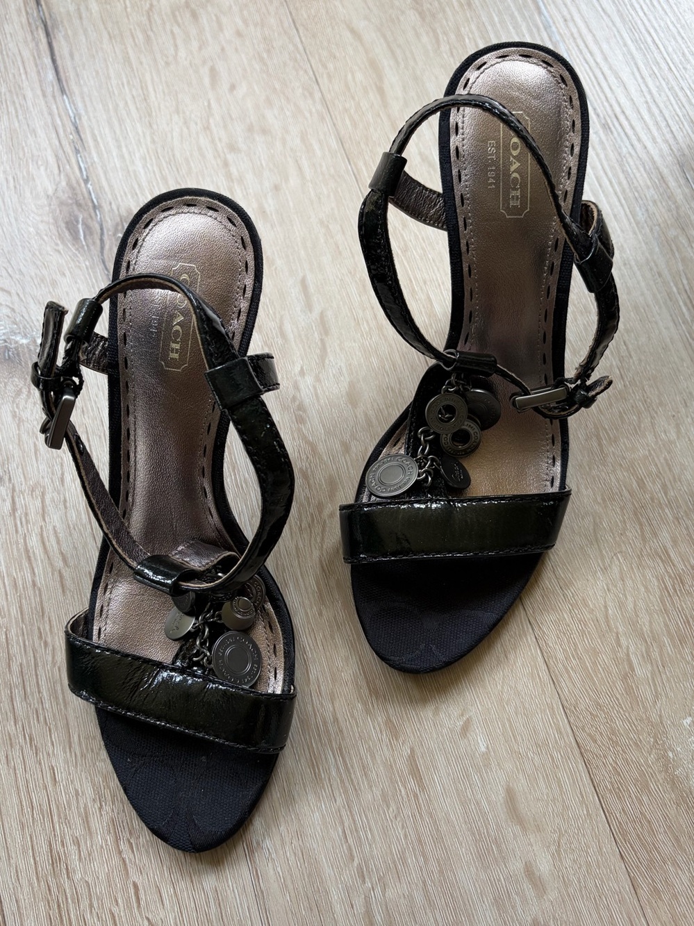 NWOB Coach Lucile Black Patent Leather T-Strap Charm Heel Sandals.